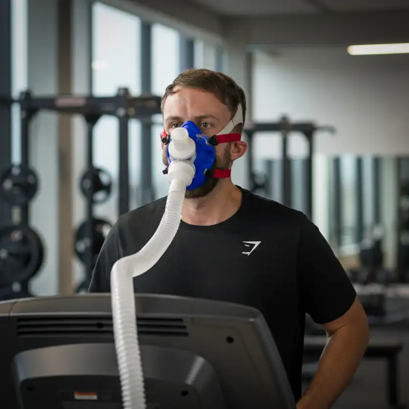 A person completing a lab VO2 max test on a treadmill